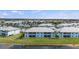 Community homes featuring lush landscaping and a lake at 5743 Sabal Trace Dr # 101B57, North Port, FL 34287