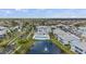 This aerial shows a luxury community surrounding a pool and pond with an attractive water fountain at 5743 Sabal Trace Dr # 101B57, North Port, FL 34287