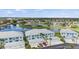Stunning aerial view of condo community nestled by a serene lake with a fountain at 5743 Sabal Trace Dr # 101B57, North Port, FL 34287