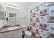 Well-maintained bathroom with a vanity and tropical-themed shower curtain at 5743 Sabal Trace Dr # 101B57, North Port, FL 34287