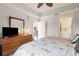 Bright bedroom features a dresser, mirror, and a ceiling fan at 5743 Sabal Trace Dr # 101B57, North Port, FL 34287