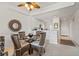 Dining area with modern table set and decor next to the kitchen and living room at 5743 Sabal Trace Dr # 101B57, North Port, FL 34287