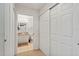 Hallway view of bathroom with a single vanity and tile flooring at 5743 Sabal Trace Dr # 101B57, North Port, FL 34287