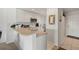 Efficient white kitchen featuring a breakfast bar and tiled floors at 5743 Sabal Trace Dr # 101B57, North Port, FL 34287