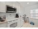 Bright kitchen features white cabinets and a small breakfast nook area at 5743 Sabal Trace Dr # 101B57, North Port, FL 34287
