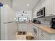 Open kitchen with white cabinets and breakfast area with water view at 5743 Sabal Trace Dr # 101B57, North Port, FL 34287