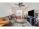 Cozy living room with comfortable seating, ceiling fan and lots of sunlight at 5743 Sabal Trace Dr # 101B57, North Port, FL 34287