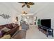 Living room with comfortable seating and modern decor that features a view of kitchen at 5743 Sabal Trace Dr # 101B57, North Port, FL 34287