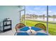 Patio seating area overlooks a serene lakeside view at 5743 Sabal Trace Dr # 101B57, North Port, FL 34287