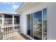Cozy balcony featuring sliding glass doors, wooden decking, and white railing, offering outdoor space at 5922 Garden Ln # A31, Bradenton, FL 34207