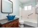 Bright bathroom featuring a vessel sink on granite countertop and bathtub with accessibility bars at 5922 Garden Ln # A31, Bradenton, FL 34207