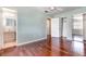 Well-lit bedroom with hardwood floors, neutral paint, open bathroom and closet at 5922 Garden Ln # A31, Bradenton, FL 34207