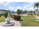 Well maintained community featuring a fountain with lush landscaping, manicured lawns, and palm trees at 5922 Garden Ln # A31, Bradenton, FL 34207