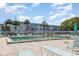 Inviting community pool area with lounge chairs, umbrellas, and palm trees, perfect for relaxation at 5922 Garden Ln # A31, Bradenton, FL 34207