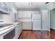 Charming kitchen features white cabinets, appliances, and hardwood floors, creating a warm and inviting space at 5922 Garden Ln # A31, Bradenton, FL 34207
