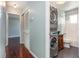 Convenient laundry area with stacked washer and dryer, plus storage, located near a full bathroom at 5922 Garden Ln # A31, Bradenton, FL 34207