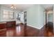 Bright living room with hardwood floors, neutral walls, open doorway and modern ceiling fan fixture at 5922 Garden Ln # A31, Bradenton, FL 34207
