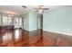 Spacious living room with hardwood floors, neutral walls, and modern ceiling fan fixture at 5922 Garden Ln # A31, Bradenton, FL 34207
