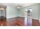 Large living room with sliding door access to a balcony, hardwood floors, and neutral walls at 5922 Garden Ln # A31, Bradenton, FL 34207