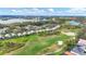 Scenic aerial view of the community featuring a golf course and lake at 6547 Oakland Hills Dr, Lakewood Ranch, FL 34202