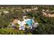 Aerial view showcasing a community pool, deck, and lush landscaping at 6547 Oakland Hills Dr, Lakewood Ranch, FL 34202