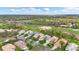 Expansive aerial view of a residential community featuring well-maintained lawns and a nearby golf course at 6547 Oakland Hills Dr, Lakewood Ranch, FL 34202