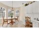 Charming breakfast nook with a round table, arched windows, and built-in desk space, bathed in natural light at 6547 Oakland Hills Dr, Lakewood Ranch, FL 34202