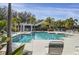 Inviting community pool with pergola and plenty of lounge seating at 6547 Oakland Hills Dr, Lakewood Ranch, FL 34202