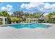 Community pool with pergola, lounge chairs, and lush landscaping at 6547 Oakland Hills Dr, Lakewood Ranch, FL 34202