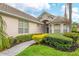 Elegant home exterior with verdant landscaping, a stone walkway, and a welcoming entrance at 6547 Oakland Hills Dr, Lakewood Ranch, FL 34202