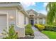 Inviting home exterior featuring lush landscaping, a charming walkway, and a well-lit entrance at 6547 Oakland Hills Dr, Lakewood Ranch, FL 34202