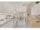 Eat-in kitchen with all white cabinets, stainless appliances, and tile floors at 6547 Oakland Hills Dr, Lakewood Ranch, FL 34202