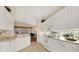 Bright, white kitchen with view of piano room at 6547 Oakland Hills Dr, Lakewood Ranch, FL 34202