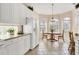 Kitchen with white cabinets, adjacent to eat-in breakfast area at 6547 Oakland Hills Dr, Lakewood Ranch, FL 34202
