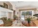 Comfortable living room with hardwood floors, a fireplace, and large windows at 6547 Oakland Hills Dr, Lakewood Ranch, FL 34202