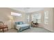 Serene main bedroom with a cozy seating area, large windows, and a light blue comforter atop a plush bed at 6547 Oakland Hills Dr, Lakewood Ranch, FL 34202