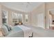 Bright main bedroom featuring a comfortable bed, desk area, and ample natural light from the multiple windows at 6547 Oakland Hills Dr, Lakewood Ranch, FL 34202