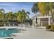 Community pool area with tables, chairs, umbrellas and lounge chairs for relaxing poolside at 6547 Oakland Hills Dr, Lakewood Ranch, FL 34202