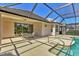 View of covered pool area with attached patio and sun loungers at 6547 Oakland Hills Dr, Lakewood Ranch, FL 34202