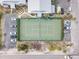 Aerial view of community tennis court surrounded by parking and lush landscaping at 6700 Gulf Dr # B8, Holmes Beach, FL 34217