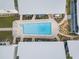 Aerial view of the community pool surrounded by walkways, landscaping, and buildings at 6700 Gulf Dr # B8, Holmes Beach, FL 34217