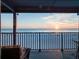 Beachfront sunset view from a comfortable balcony seating area at 6700 Gulf Dr # B8, Holmes Beach, FL 34217