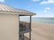 Balcony overlooking the beach with table and chairs offering stunning ocean views at 6700 Gulf Dr # B8, Holmes Beach, FL 34217