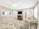 Cozy bedroom with TV, chair, and coastal decor offers a relaxing retreat with plantation shutters at 6700 Gulf Dr # B8, Holmes Beach, FL 34217