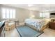Bright bedroom features a large bed, sitting chair, and mirrored wall, creating a spacious and airy feel at 6700 Gulf Dr # B8, Holmes Beach, FL 34217