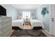 Serene bedroom featuring twin beds, a decorative lamp, and charming beach-themed wall art at 6700 Gulf Dr # B8, Holmes Beach, FL 34217