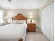Bedroom featuring a wooden bed frame, side table, and a closet for storage at 6700 Gulf Dr # B8, Holmes Beach, FL 34217