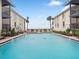 Community pool between buildings with lounge chairs and beach access at 6700 Gulf Dr # B8, Holmes Beach, FL 34217