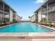 Community pool with a 7 ft 6 in depth, surrounded by well-maintained landscaping at 6700 Gulf Dr # B8, Holmes Beach, FL 34217