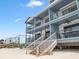 Condo building on pilings with multiple balconies overlooking the beach at 6700 Gulf Dr # B8, Holmes Beach, FL 34217